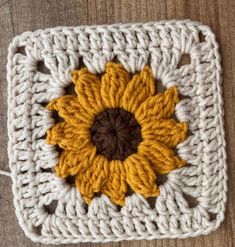 a crocheted square with a sunflower on it