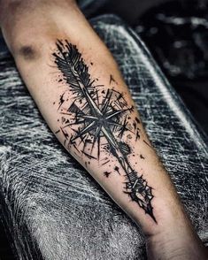 a man's arm with an arrow and stars tattoo on the left side of his arm