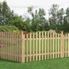 a wooden fence is shown in the grass