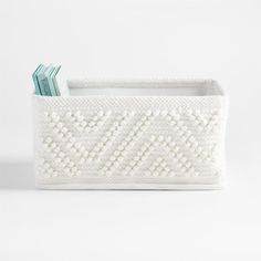 a white basket with two books in it