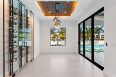 an empty room with many glasses on the wall and in front of it is a pool