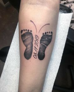 a tattoo with two footprints and the words, do not touch me on it's arm