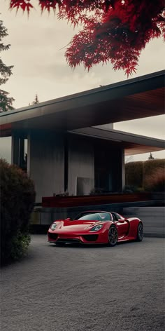 a red sports car parked in front of a house