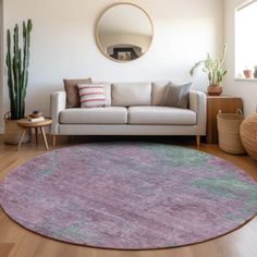 a living room filled with furniture and a round rug