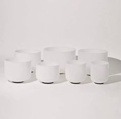 six white cups sitting on top of each other