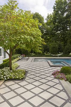 an outdoor garden with a pool and trees