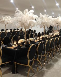 the tables are set with black linens and gold chairs for an elegant dinner party