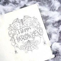 an open notebook with the words happy halloween written in black ink on top of it