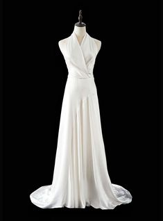 a white dress on a mannequin with an open back and draped over it