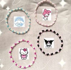 four bracelets with hello kitty designs on them