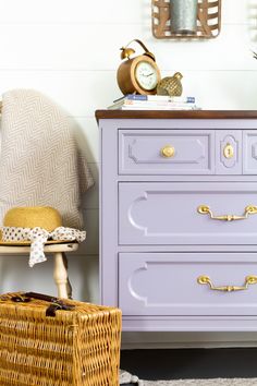 a purple dresser sitting next to a white wall