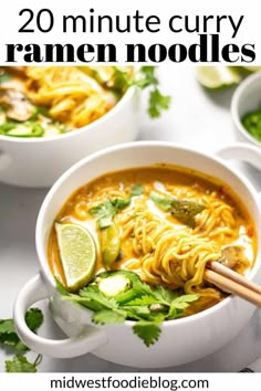 three bowls of soup with chopsticks on the side and lime slices around them