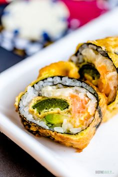 two pieces of sushi on a white plate