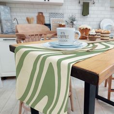 a table topped with a coffee cup and plate