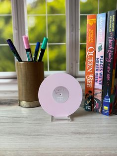 a desk with books, pens and pencils on it