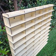 a large wooden shelf sitting on top of a lush green field