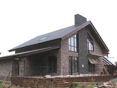 an old brick house with a metal roof