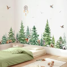 a bedroom with trees and animals painted on the wall