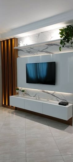 a large flat screen tv mounted to the side of a wall in a living room