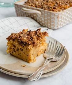 a piece of pie on a plate with a fork next to it and another dish in the background