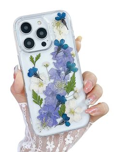 a woman holding an iphone case with flowers on it