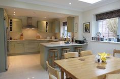 a kitchen filled with lots of counter top space next to a dining room table and chairs