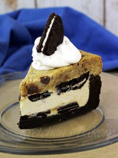 a piece of cake on a plate with whipped cream and oreo cookies in the middle