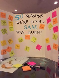 there is a sign that says 50 reason we're happy sam was born on it