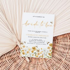 a white and yellow floral bridal - to - be card sitting on top of a wicker basket