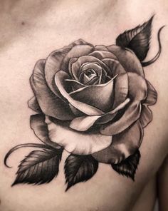 a black and white rose tattoo on the chest