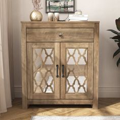 Simple storage meets farmhouse flair in this 31'' accent cabinet. Made from engineered wood, it showcases a classic silhouette with a natural wood grain finish that adds a rustic feel to your living room or dining space. This sideboard features a single drawer for utensils and tools. Two cabinet doors show off Moroccan trellis paneling and mirrored glass, opening to enclosed storage for any books, decor, or dishes. Adjustable shelves inside the cabinets allow you to customize the storage space t Accent Cabinets, Farmhouse Flair, Trellis Panels, Door Accent Cabinet, Books Decor, Accent Chests And Cabinets, Farm House Colors, Moroccan Trellis, Cabinet Ideas