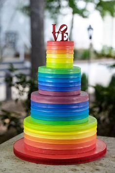 a multi colored cake with the word love on top