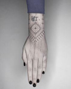 a woman's hand with tattoos on it