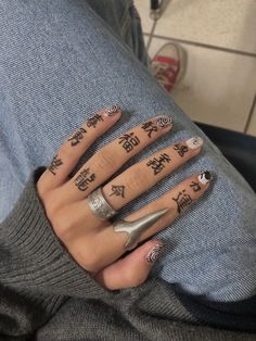 a person with some tattoos on their fingers