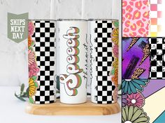 two personalized tumbles are sitting on a wooden stand next to colorful wallpaper