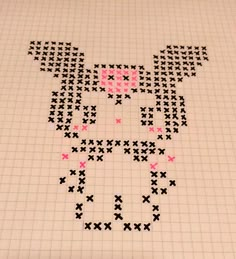 a cross stitch pattern with pink and black dots in the shape of a dog's head