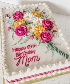 a birthday cake decorated with flowers and the words happy 69th birthday mom