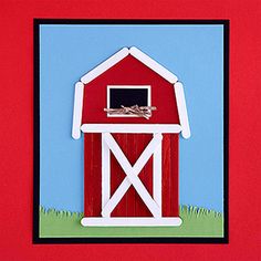 a paper cut out of a red barn