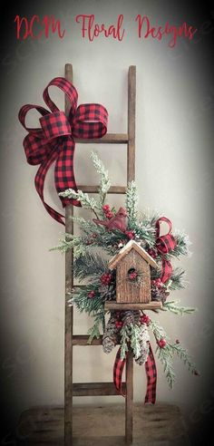 a wooden ladder with a birdhouse on it and red ribbon around the top that says mom, floral designs