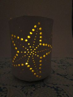 a candle that is lit up with some lights in the shape of a snowflake