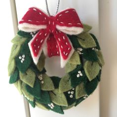 a christmas wreath hanging on a door