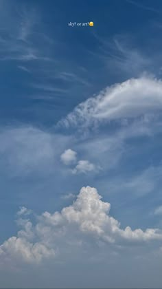 two people on the beach flying a kite in the sky with clouds and sun behind them