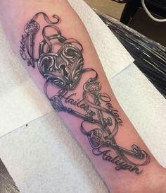 a black and white tattoo on the arm of a person's leg with two keys