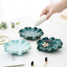 Sacred Soap Dishes Try this lotus leaf soap dish to decor your bathroom now, Enjoy the zen and unique stylish. Include dark and teal green colors, and the 1.18 inch corner height to self dran the water. 5.11 inches length, with shiny surface mount, suitable for soaps of various sizes, variety occasion to place Made of high-quality ceramic, durable and easy to clean. Creative leaf related stuff, suitable for bathroom, kitchen room, get the cozy feeling everytime. Ceramic Soap Holder, Soap Dish Ideas, Soap Storage, Teal Green Color, Ceramic Soap Dish, The Zen, Soap Dishes, Lotus Leaves, Lotus Leaf