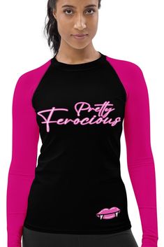 a woman wearing a black and pink shirt with the words pretty ferocia written on it