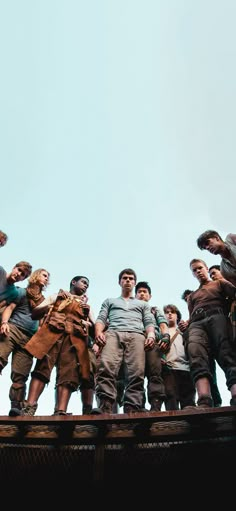 a group of people standing on top of a bridge