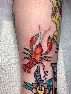 a crab and anchor tattoo on the leg