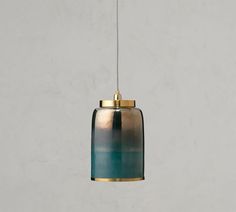 a blue and gold colored light hanging from a ceiling fixture with a white wall in the background