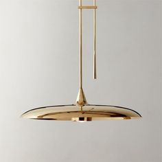 a large brass pendant light hanging from a ceiling