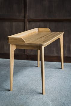 a wooden table sitting on top of a blue carpet